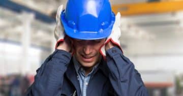 Generator operating at a construction site with visible noise insulation panels